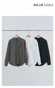 Detailed close-up of premium business shirts showing the lapel collar and chest pocket details