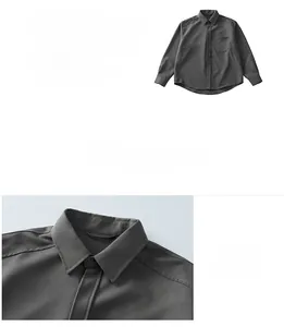 Detail of dark grey business shirt showing fabric texture, classic collar and chest pocket