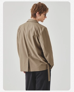 Rear view of casual khaki blazer with single vent and decorative strap detailing