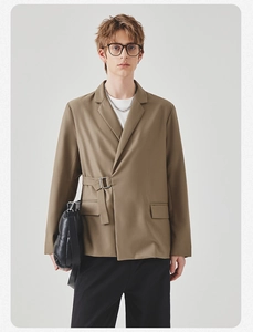 Detail view of khaki casual blazer featuring modern asymmetric side-buckle closure