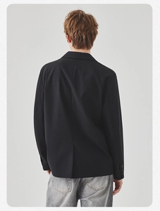 Rear view of black casual blazer showing back vent detail and buttoned sleeve cuffs