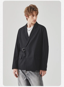 Detail view of the side buckle closure on a casual black men's oversized suit jacket