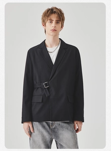 Detail view of black casual blazer featuring unique side metal buckle and asymmetrical closure