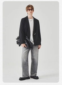 Detail of men casual black blazer with metal ring buckle and gradient grey jeans outfit