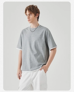 Detail van grijs gelaagd T-shirt met faux-twin kraag en wit contrasterende zoomafwerking