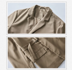 Detail view of khaki blazer showing notch lapel and pocket with metal buckle belt