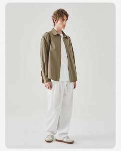 Men's olive cargo shirt styled with white T-shirt and joggers in a full outfit view