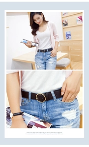 Detail of a black leather belt with a round gold buckle on a stylish model outfit
