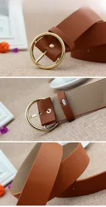 Macro shot of brown PU leather belt featuring a polished gold round buckle and stitching