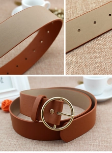 Detail of brown PU leather belt featuring a round gold buckle and textured finish