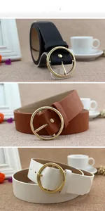 Detailed view of round gold buckles on black, brown, and cream faux leather belts
