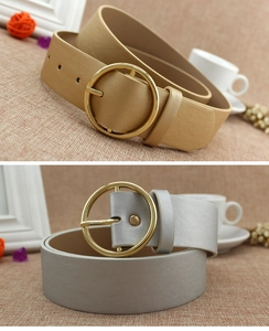 Detail of champagne gold and silver PU leather belts with large round metal buckles