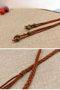 Detail of bohemian braided brown suede belt with vintage wooden beads and knot accents