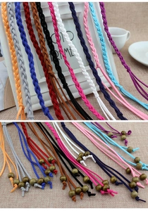 Detail view of woven suede cords in multiple colors with vintage wooden bead accents