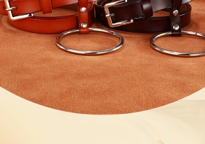 Détail des ceintures en cuir marron et caramel avec grand anneau métallique et rivets