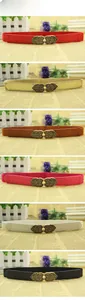 Detail showing vintage heart metal buckle and elastic skinny belts in multiple colors