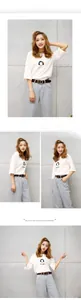 Fashionable summer outfit featuring a white printed T-shirt and high-waist jeans with belt