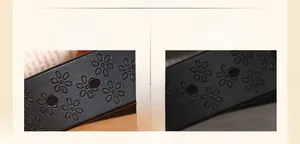 Detail shot of the embossed floral patterns and premium black leather texture of the belt