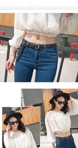 Détail d'une ceinture tressée en cuir noir portée avec un jean et une tenue élégante