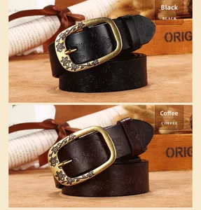 Close-up of vintage butterfly embossed leather belt with engraved floral buckle