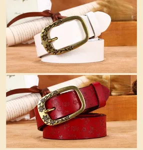 Close-up of vintage bronze buckle and floral embossed leather on a women belt