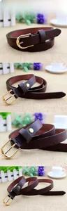 Detail of coffee brown leather slim belt with a gold oval pin buckle and cross pattern