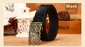 Close-up of vintage bronze carved buckle and embossed floral patterns on black leather belt