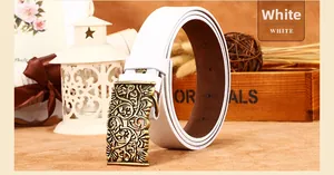 Detail of white embossed leather belt with vintage floral hollow carved bronze buckle