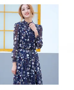 Close-up of a woven black skinny belt paired with a navy blue floral print dress