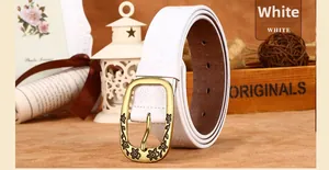 Detail of vintage embossed floral pattern on white leather belt with antique buckle