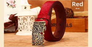 Detail of red leather belt featuring vintage bronze buckle with hollow floral carvings