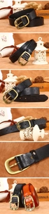 Detailed macro of vintage floral embossed leather belt with rustic brass buckle