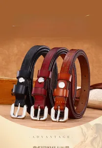 Detail of three leather belts featuring floral embossing and square silver buckles