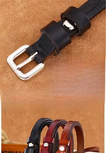 Close-up of floral embossed leather belts with vintage silver metal pin buckle detail