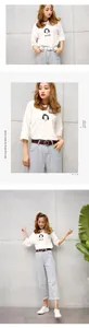 Women's leather belt with round gold buckle styled on casual high-waisted denim jeans