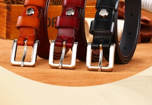 Detailed close-up of retro hollow genuine leather belts with silver pin buckles in three colors