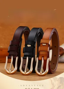 Three slim leather belts in black and brown with polished gold U-shaped metal buckles