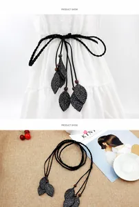 Detail of bohemian woven belt with leaf pendants, polka dots and wooden beads