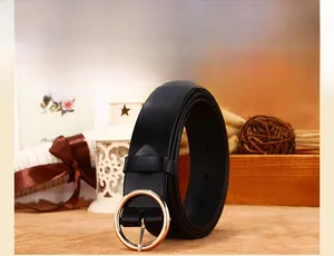 Detail of a black leather waist belt with a round golden metal buckle and adjustment holes