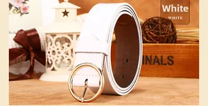 Detail of white leather belt with a round golden buckle on a decorative gift background