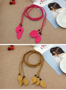 Detail of woven leaf belt in rose red and ginger yellow with intricate handmade tassels