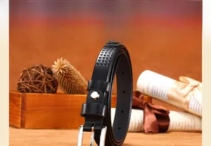 Detail of black hollowed leather belt with silver pin buckle on a vintage rustic background