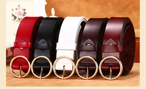 Detail of five assorted leather belts for women with polished gold circular metal buckles