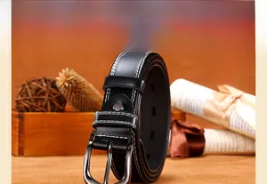 Close-up of black leather belt featuring contrast white stitching and metal pin buckle