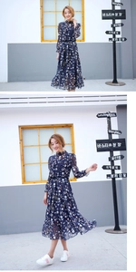 Close-up of lightweight chiffon floral dress with elegant waist tie and leaf patterns