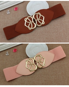 Detail of interlocking heart metal buckles on elastic waist belts in brown and pink colors
