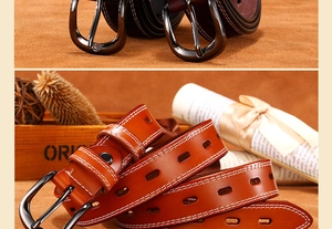 Macro detail of vintage leather belt with white contrast stitching and gunmetal pin buckle