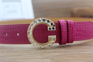Close-up of luxury rose red crocodile pattern PU belt with gold crystal G-buckle detail