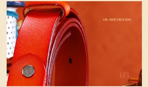 Detail of red leather belt showing oil side process craftsmanship and smooth metal buckle