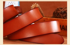 Close-up of brown leather belt showing fine texture and natural luster with neat edges